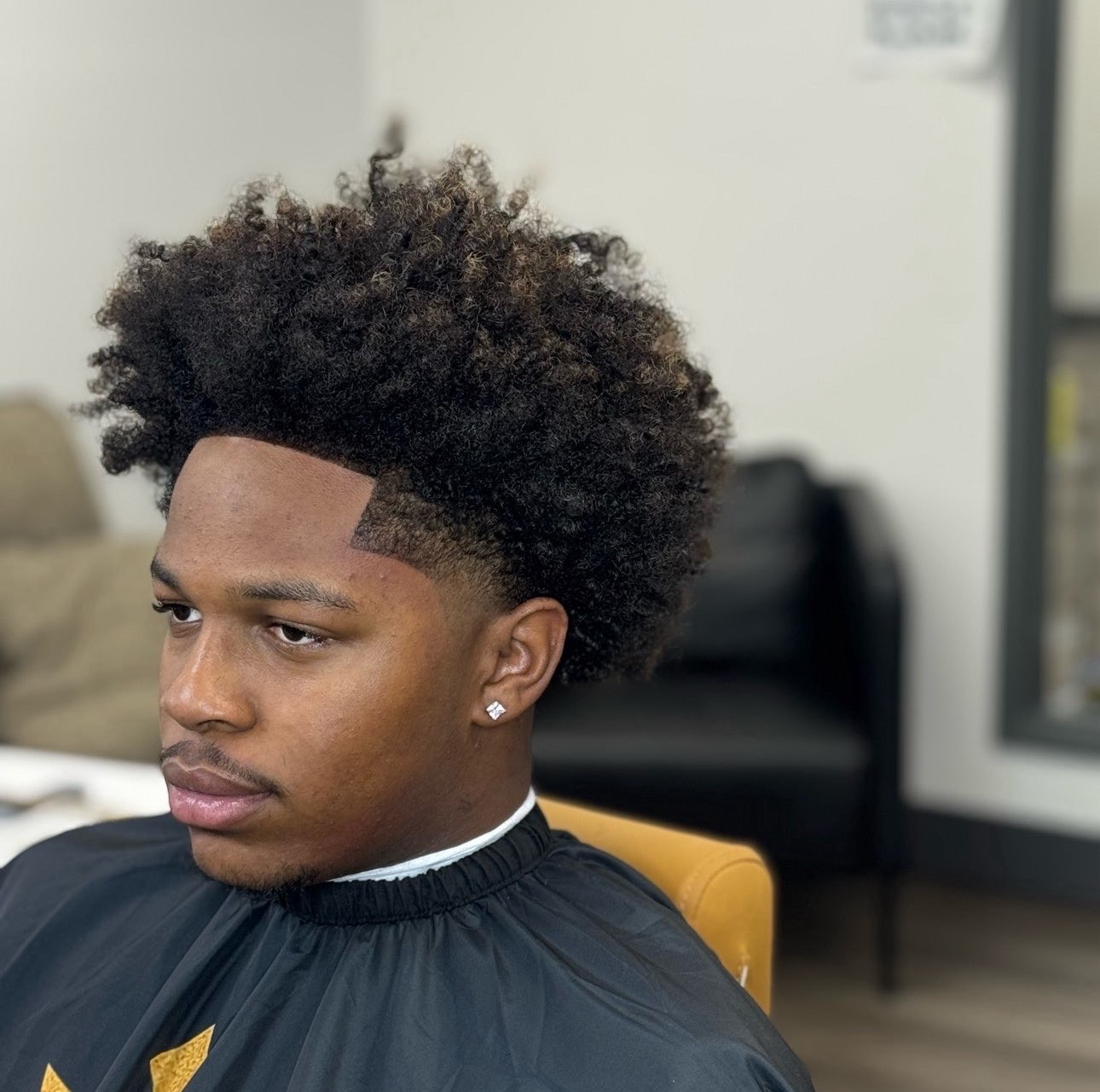 Curly afro top with sharp lineup and skin fade